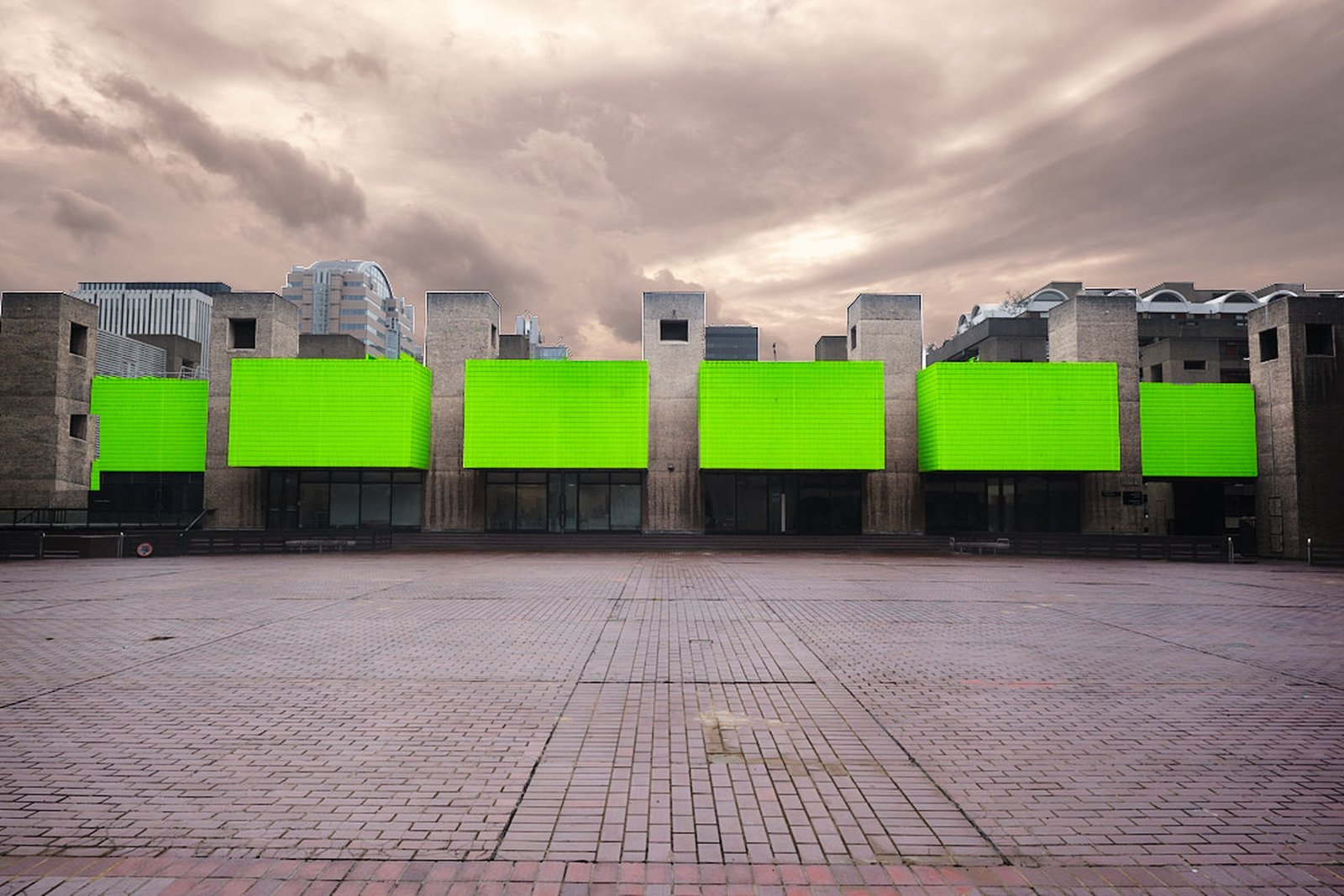 Barbican Centre, London, six green lightbox screens against a brutalist concrete skyline