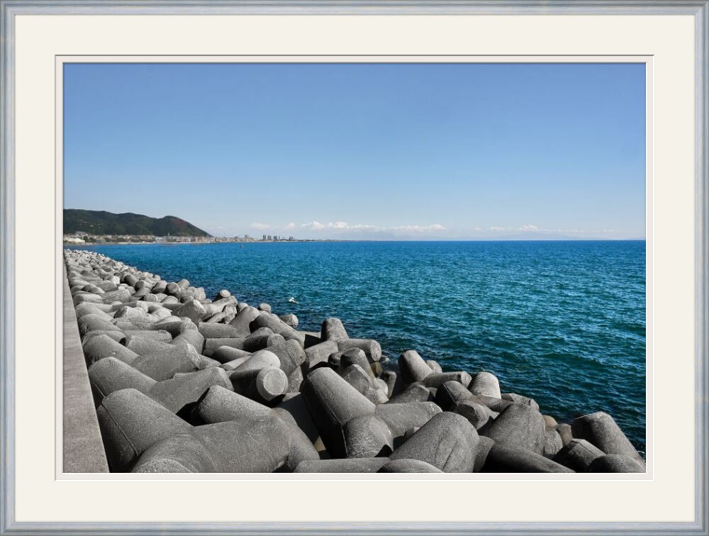 Framed coastal photograph in a brushed silver frame